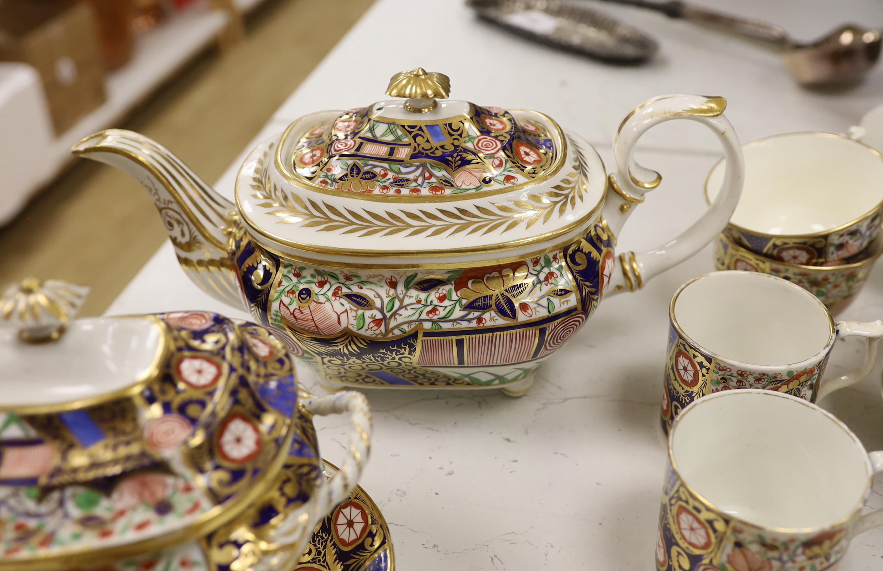 An early 19th century Derby Japan pattern part tea and coffee set, including cups and saucers, teapot, milk jug and bowl